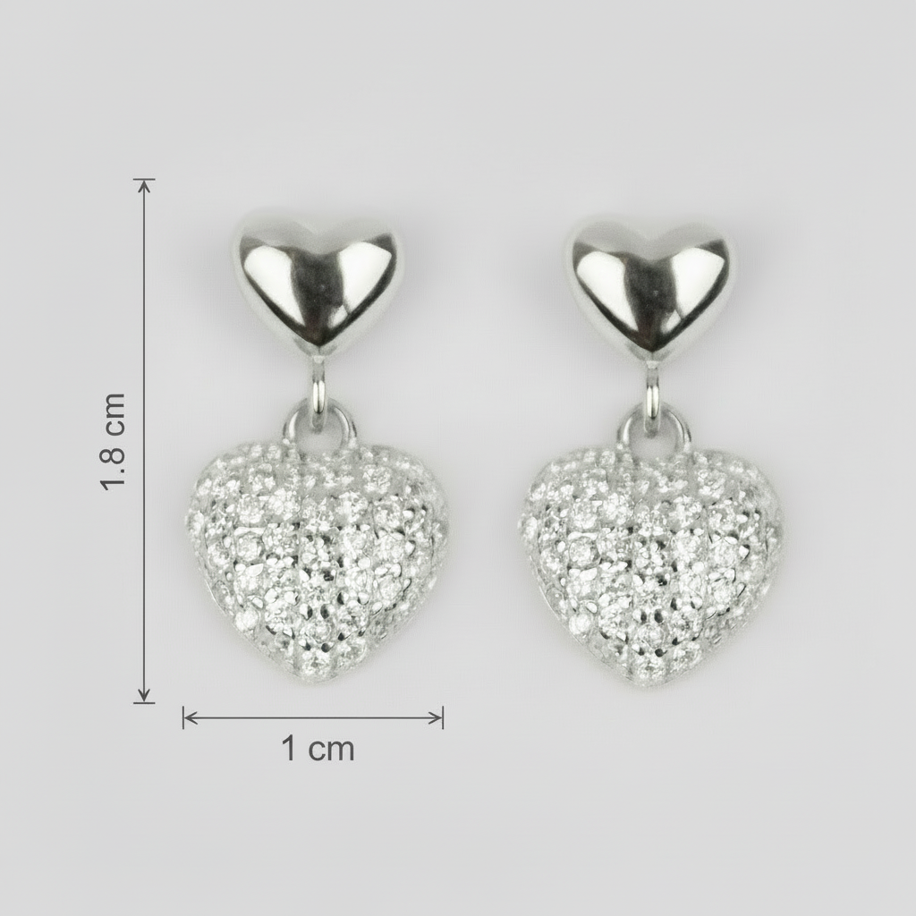 Heart-shaped silver earrings with clear stones and measurements on a light gray background