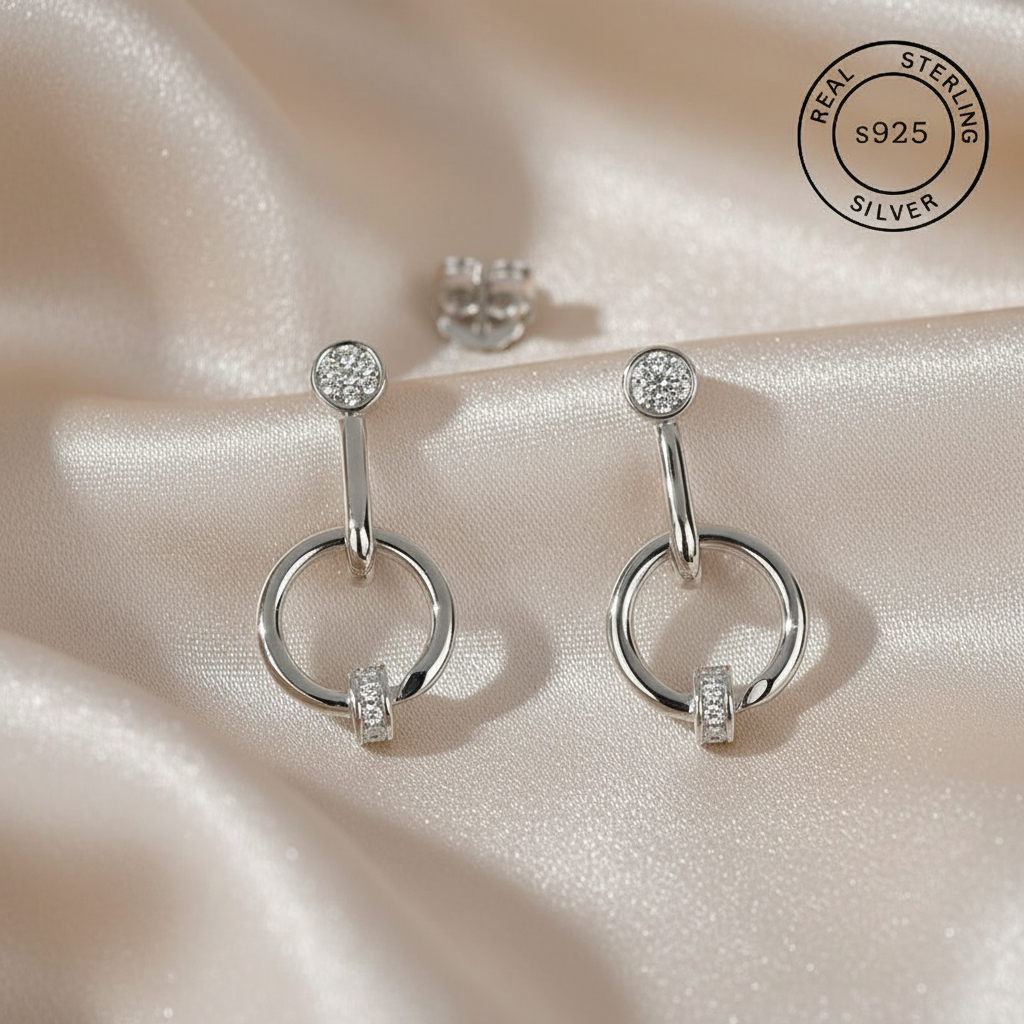 Silver earrings with zircon stones  featuring 'Real Sterling Silver' stamp.