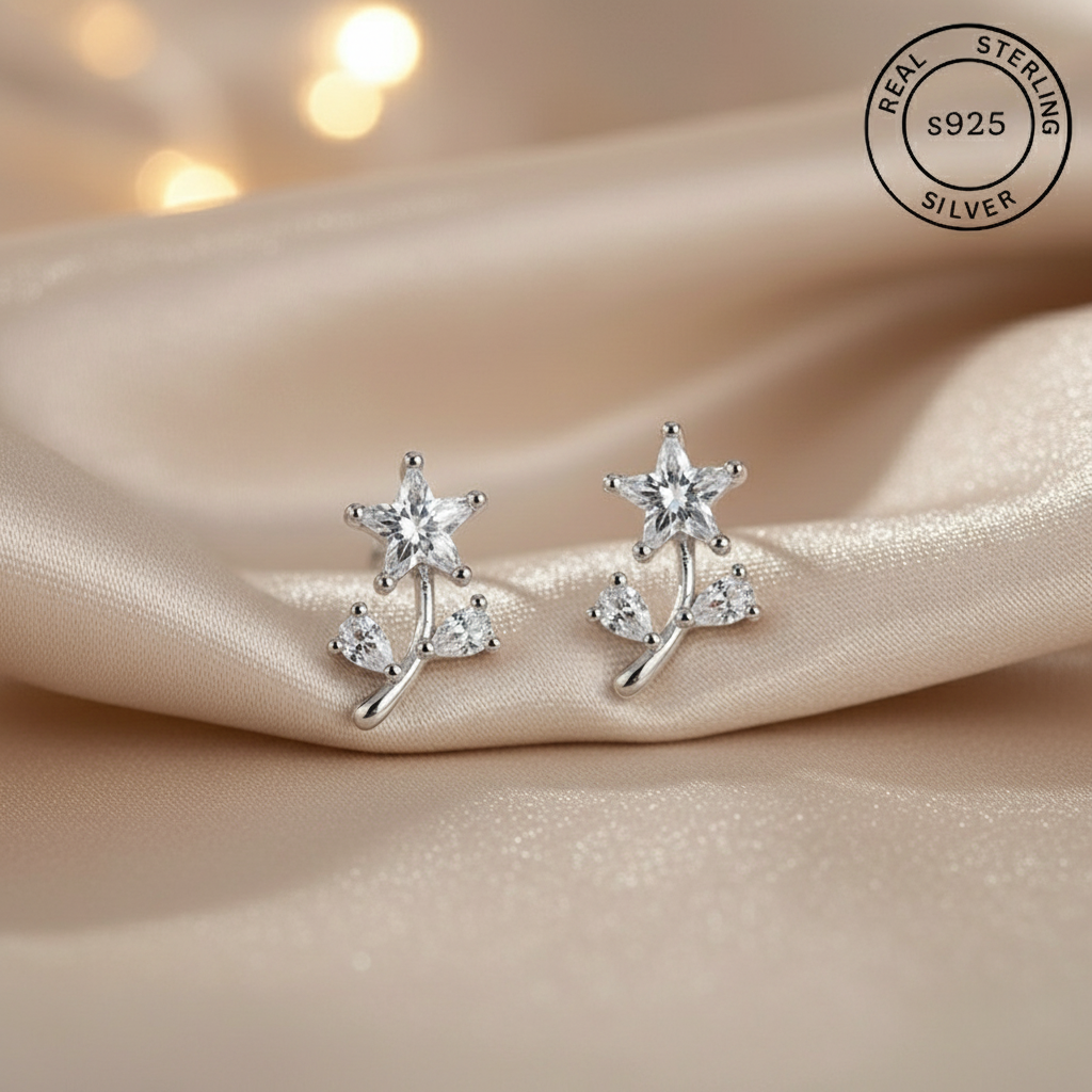 Flower-shaped silver earrings with AAA+ Cubic zircons , featuring 'Real Sterling Silver' stamp.