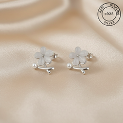 Silver flower-shaped earrings with 'Real Sterling Silver 925' stamp.