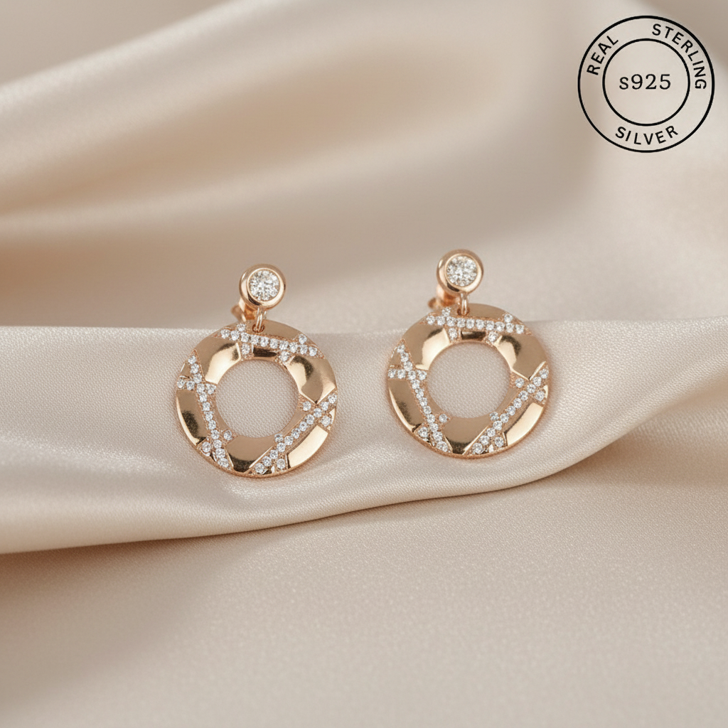 Rose gold earrings with diamonds on , featuring 'Real Sterling Silver' stamp.