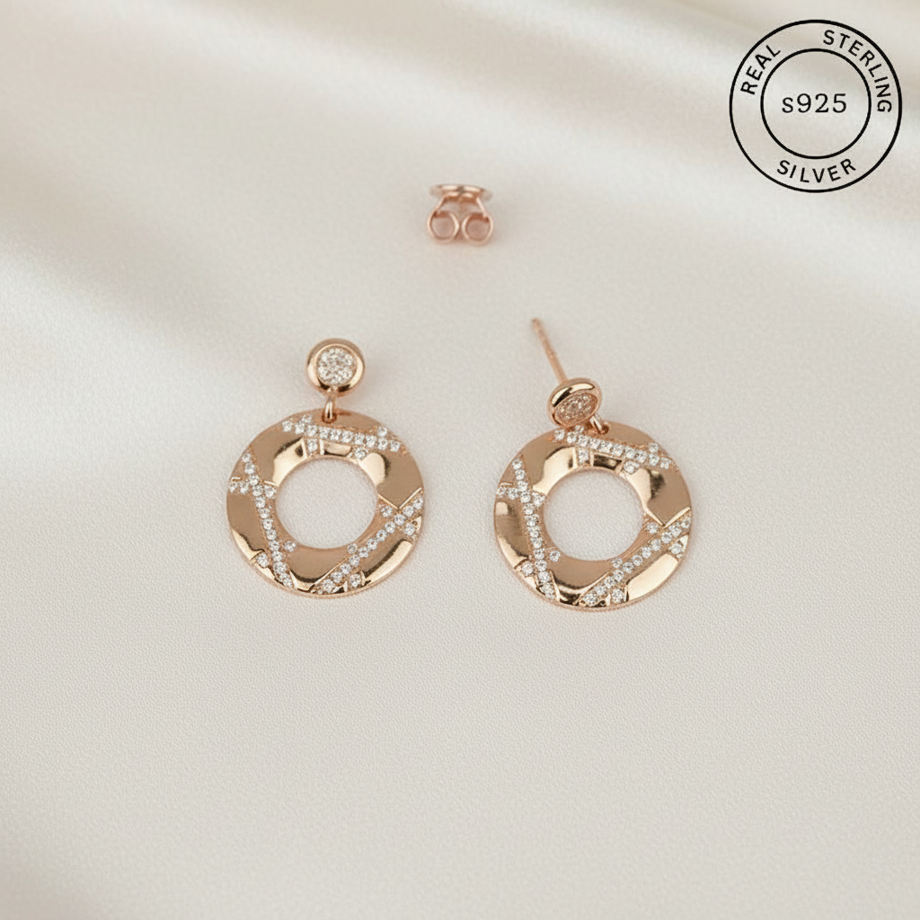 Rose gold hoop earrings with Zircon stones featuring 'Real Sterling Silver s925' label.