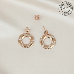 Rose gold hoop earrings with Zircon stones featuring 'Real Sterling Silver s925' label.