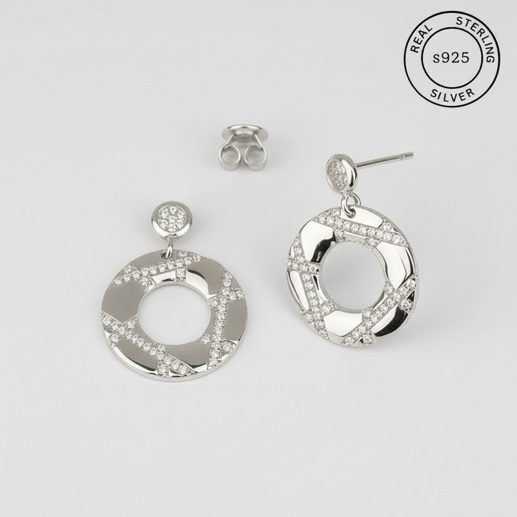 Silver hoop earrings with Zirconia diamonds stones featuring 'Real Sterling Silver' stamp.