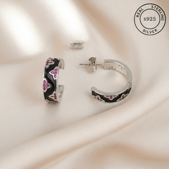 Silver hoop earrings with black and pink floral design  featuring 'Real Sterling Silver' stamp.