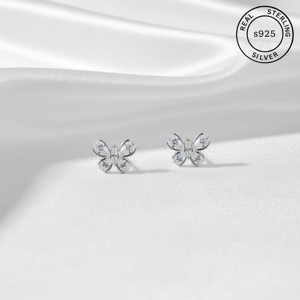 Butterfly-shaped silver earrings on a white background with 'Real Sterling Silver' label.