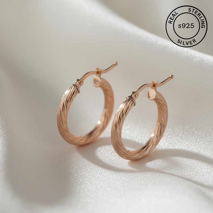 Rose gold hoop earrings on a light background with 'Real Sterling Silver 925' stamp.