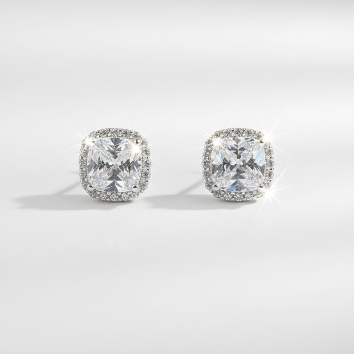 Pair of diamond stud earrings on a light gray background
