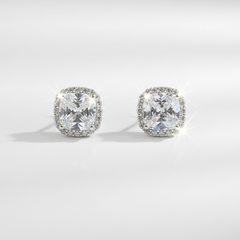 Pair of diamond stud earrings on a light gray background