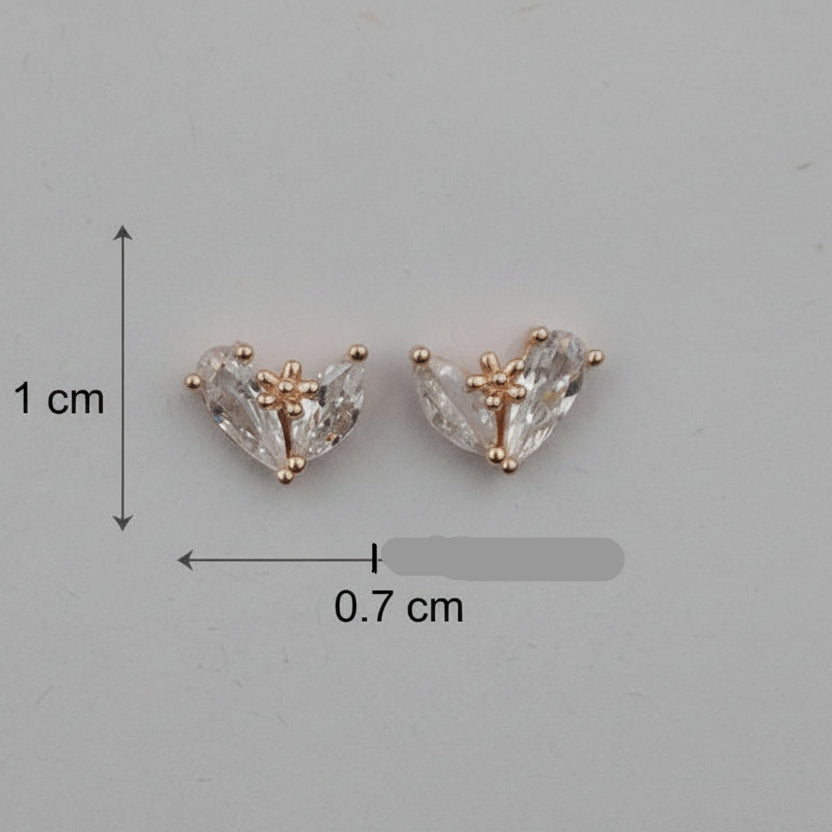Heart-shaped diamond earrings with size measurement on a gray background