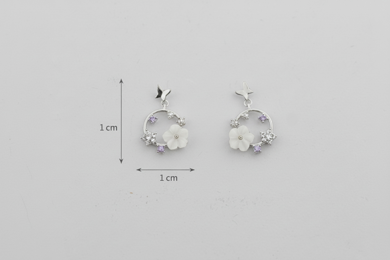 Pair of floral earrings with measurements on a gray background