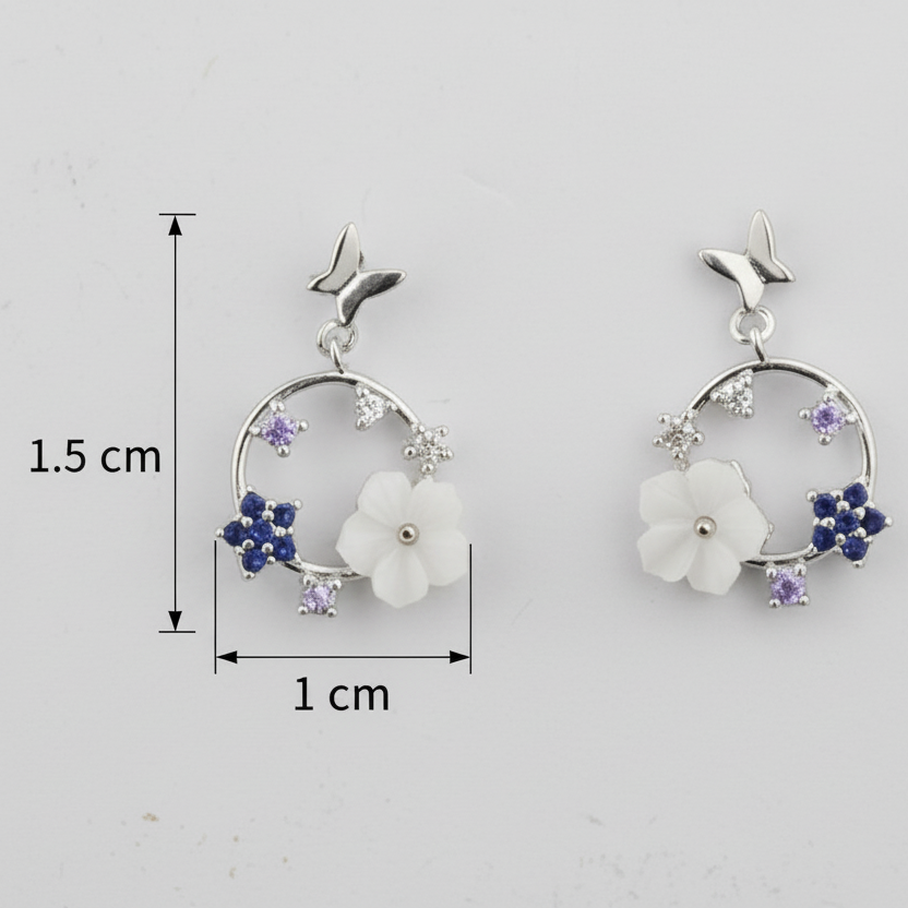Pair of earrings with floral design and measurements on a light gray background