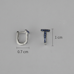 Silver hoop earrings with blue gemstones and size measurements on a gray background