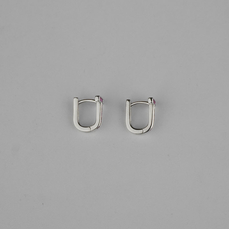 Pair of silver hoop earrings on a gray background
