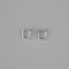 Pair of silver hoop earrings on a gray background