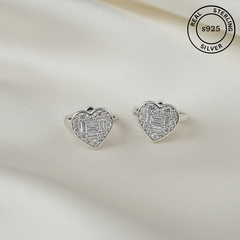 Heart-shaped silver earrings with clear stones on a light background, labeled 'Real Sterling Silver s925'.