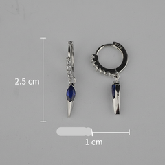 Two silver earrings with blue gemstones and measurements on a gray background