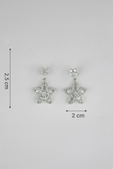 Star-shaped earrings with measurements on a gray background