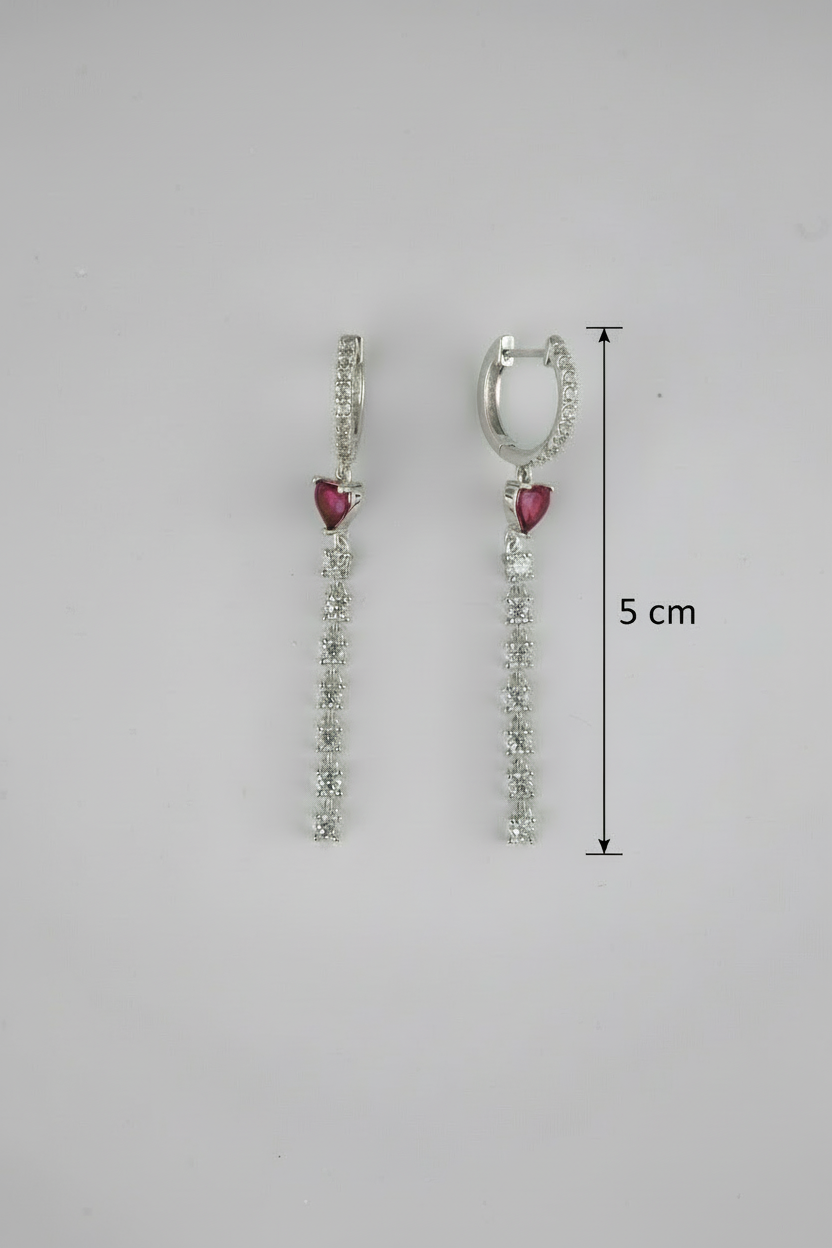 Pair of earrings with heart-shaped gemstones and measurements on a gray background