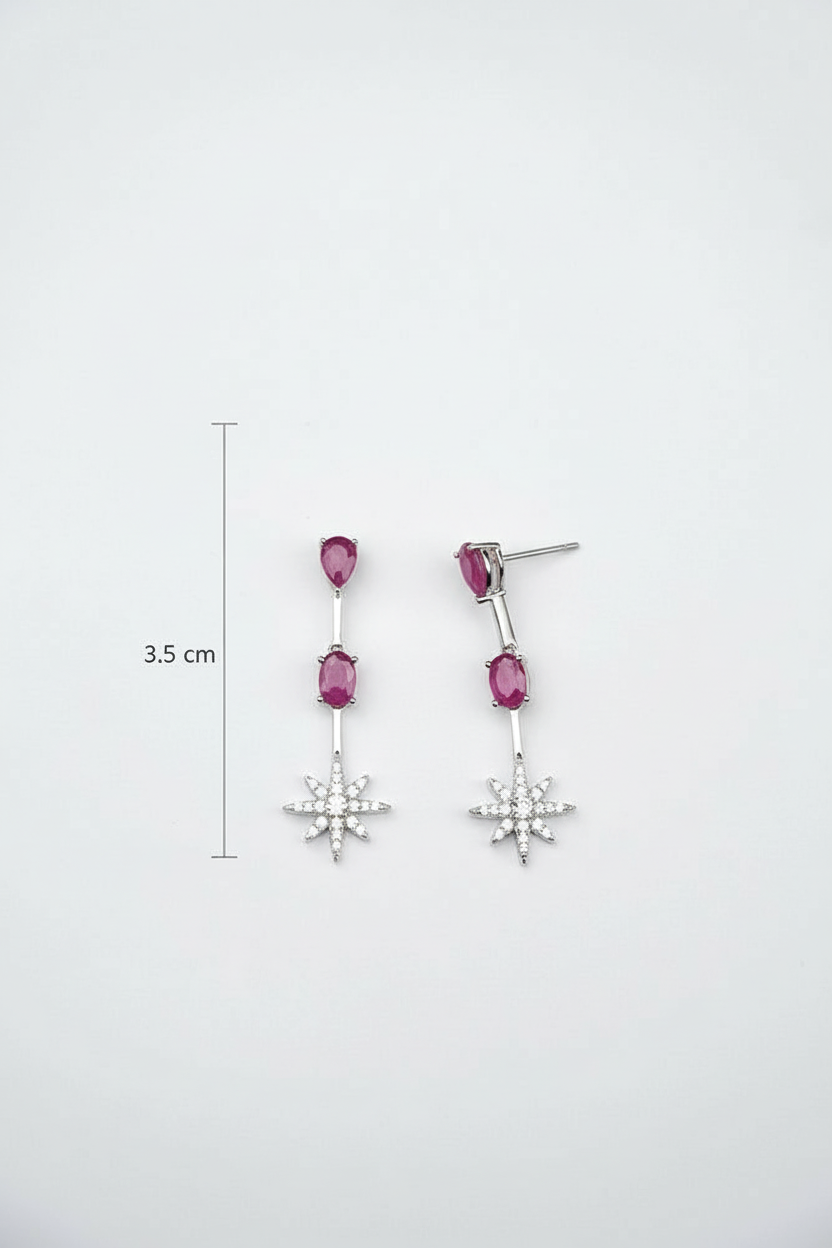 Pair of earrings with pink gemstones and star-shaped drops on a white background