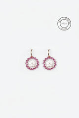 Pair of pink earrings on a white background