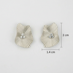 Silver earrings with textured design and CZ, shown with measurements on a light gray background.
