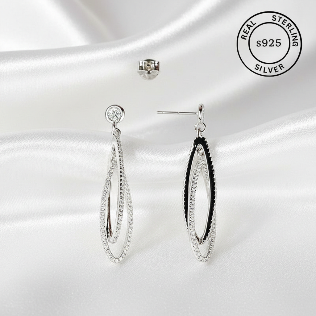 Silver earrings on a white background with 'Real Sterling S925' label.