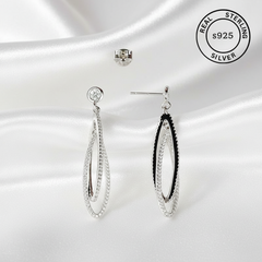 Silver earrings on a white background with 'Real Sterling S925' label.