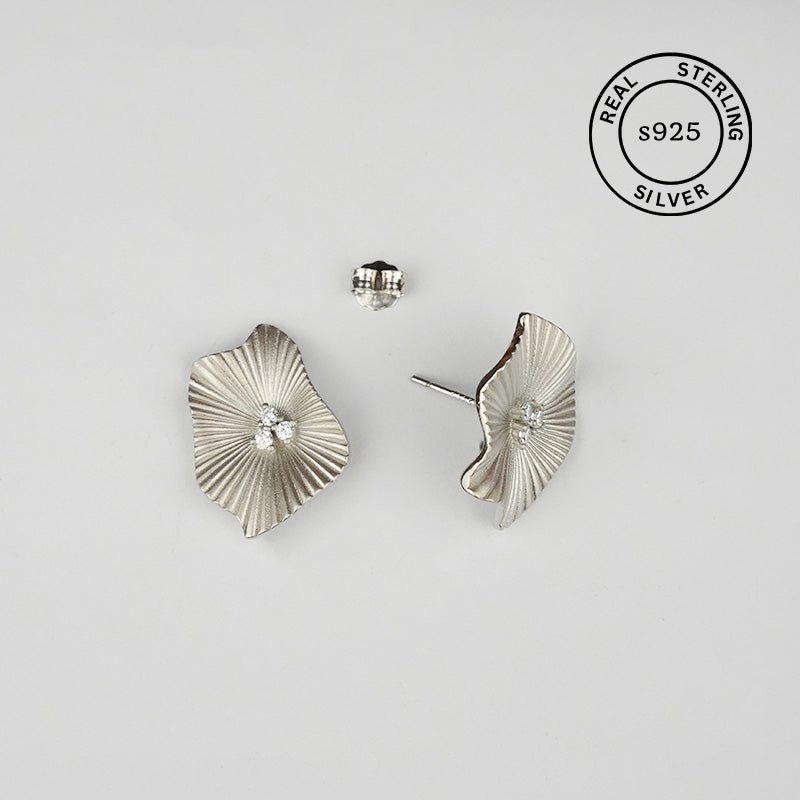 Silver leaf-shaped earrings on a light gray background with 'Real Sterling Silver' stamp.