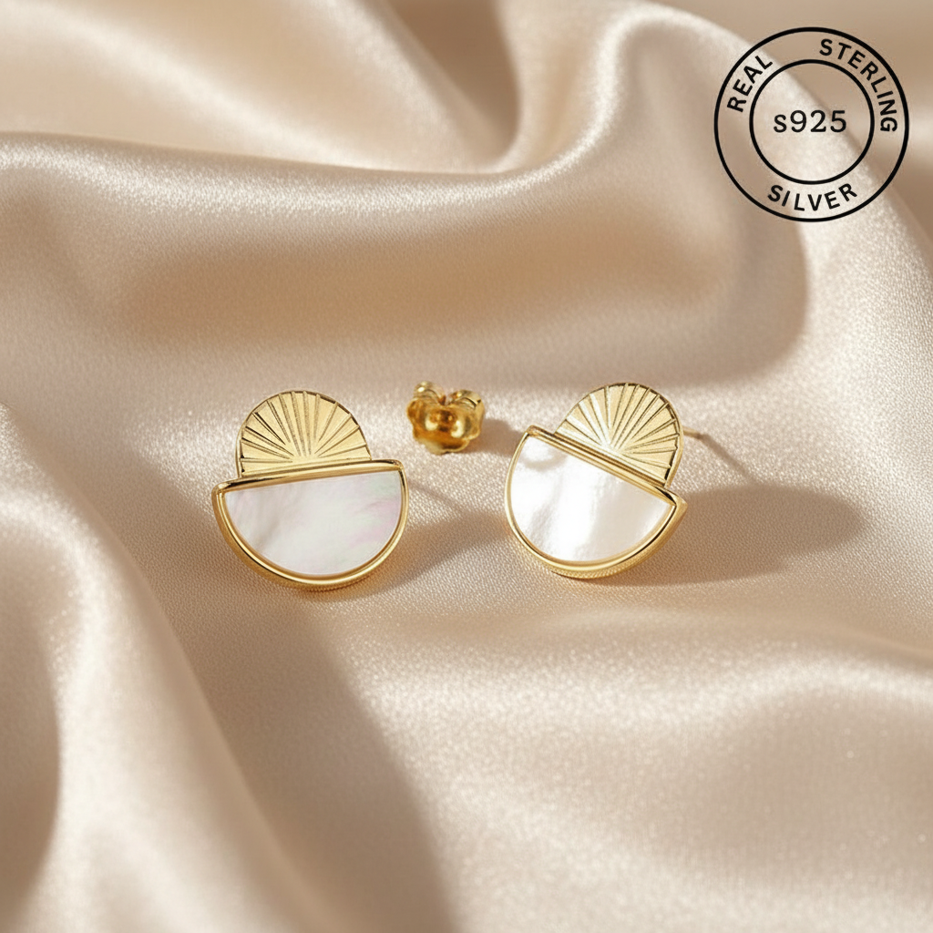 Gold and white half-circle earrings on beige fabric with 'Real Sterling Silver 925' stamp.