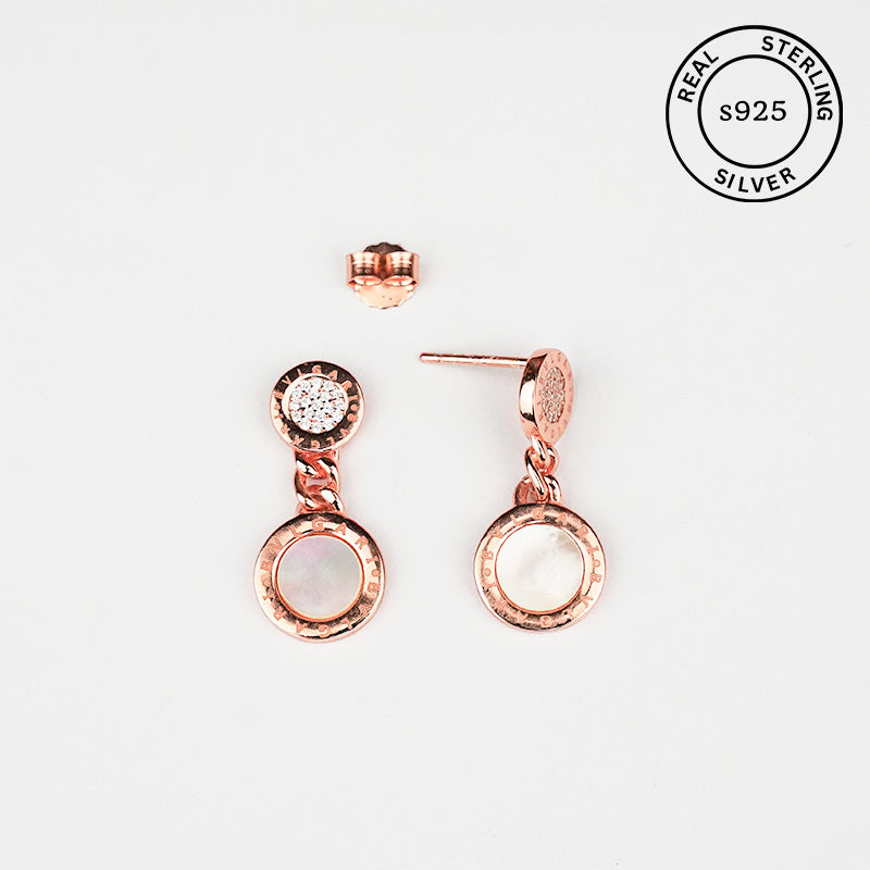 Rose gold earrings with gemstones on a white background, featuring 'Real Sterling S925' stamp.