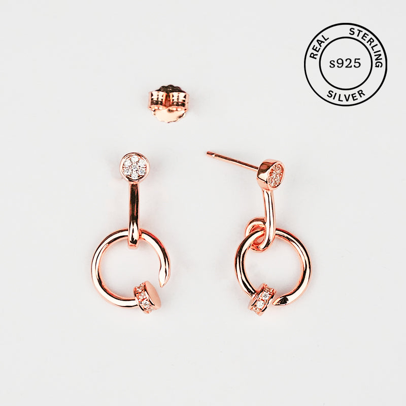Rose gold hoop earrings with clear gemstones on a light gray background, featuring 'Real Sterling Silver s925' stamp.