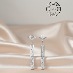 Silver Sleek Modern Dangles with zircon stones on a satin surface, featuring 'Real Sterling Silver' certification.