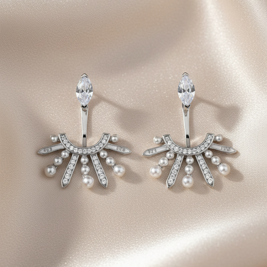 Pair of silver earrings with pearls and crystals on a beige background