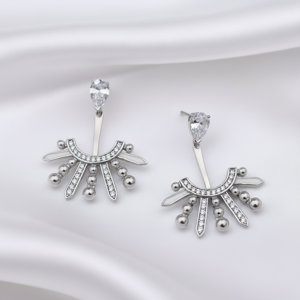 Pair of silver earrings with decorative design on a white background