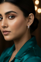 Close-up of a woman wearing 925 Sterling Silver Rosé Glow Hoop Earrings