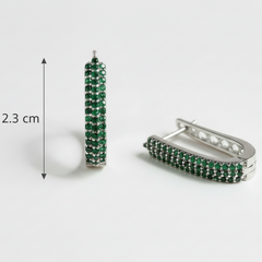 Pair of hoop earrings with green gemstones and silver accents, shown with a measurement label on a white background.