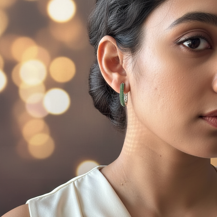 Close-up of a woman wearing green hoop earrings